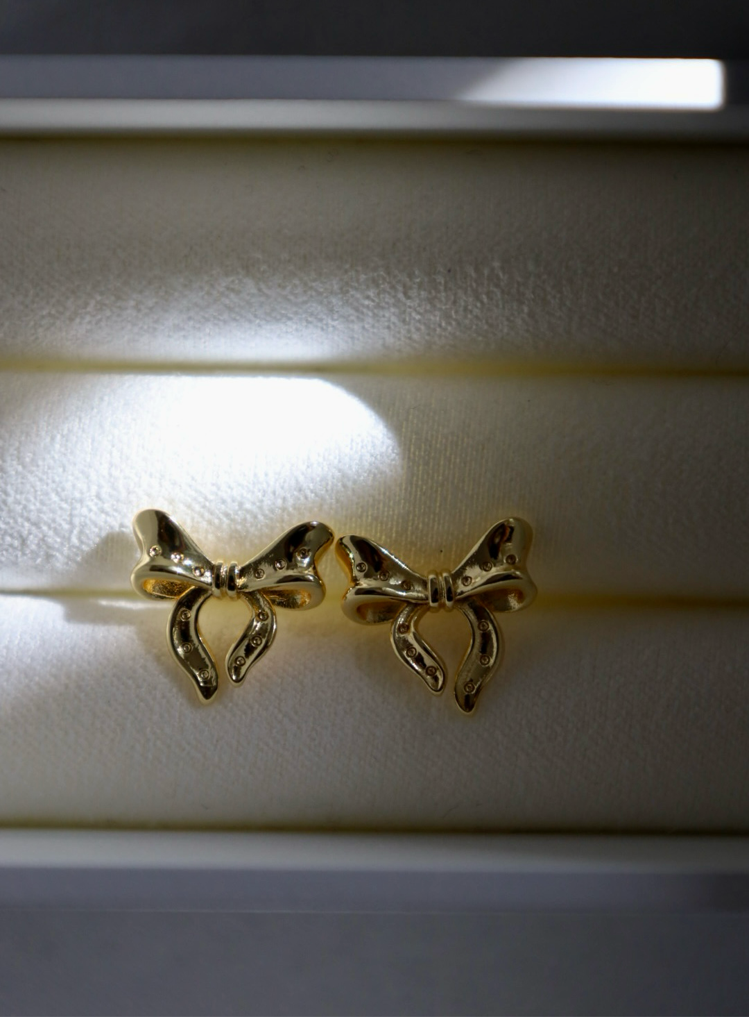 Gold bow stud earrings